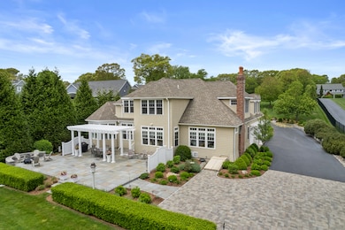 The meticulously laid pavers lead to a spacious bl