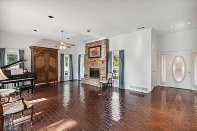 Beautiful brick flooring and a floor to ceiling wood burning fireplace.