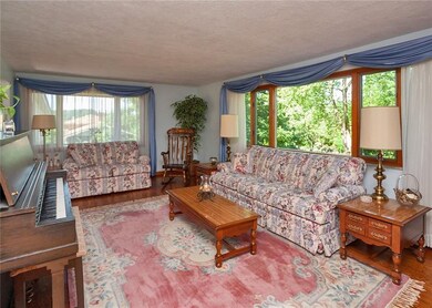 The living room boasts beautiful pegged hardwood f