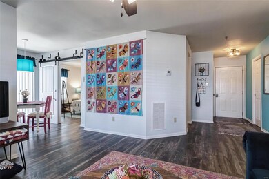 Beyond the barn door is a spacious bedroom.