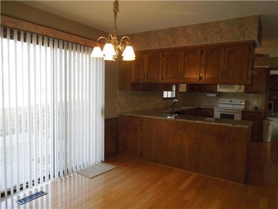 Large eat in area with entrance to back patio.