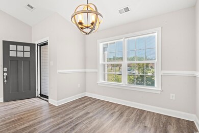 Interior space with vaulted ceiling, a chandelier,