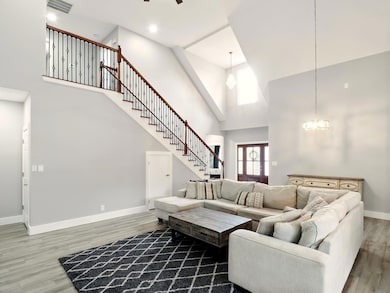 Living room featuring wood finished floors, a cha