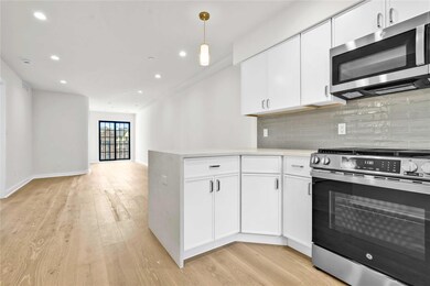 Kitchen featuring stainless steel appliances, light wood-style flooring, decorative backsplash, white cabinetry, and recessed lighting