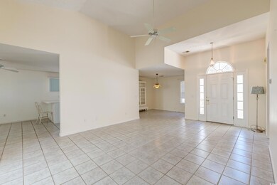 Foyer with high vaulted ceiling, light tile patter