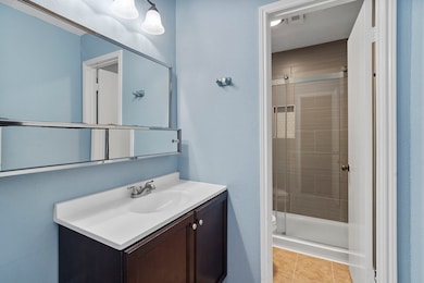 The primary bathroom offers tile flooring, sleek l