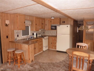 Kitchen with bar stools and dinette area