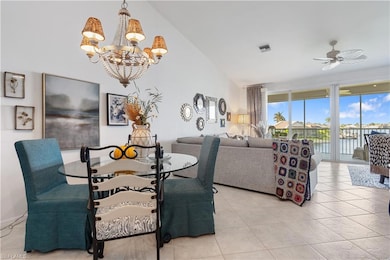 Dining room featuring lofted ceiling, light tile p
