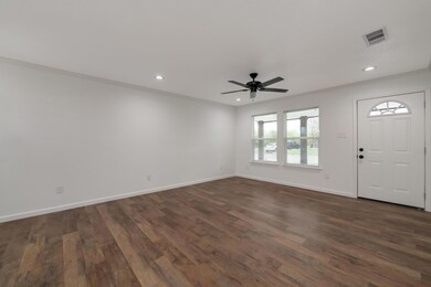 Foyer entrance featuring ceiling fan, crown moldin