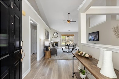 Entrance foyer with vaulted ceiling, a ceiling fan