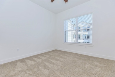 Primary bedroom with large window and ensuite bath