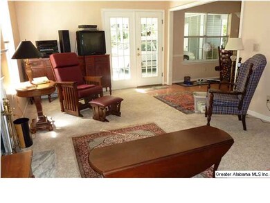 The living room, with brand new carpet, toward fre