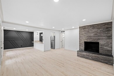 Unfurnished living room with ornamental molding, s