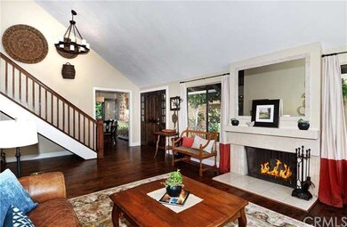Large entry into living room with fireplace