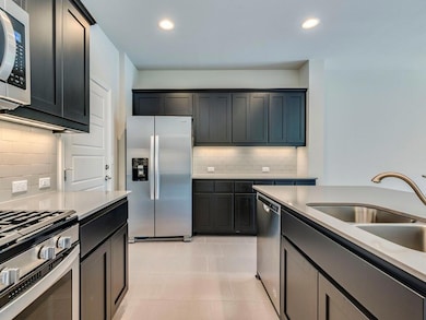 Kitchen featuring stainless steel appliances, tas