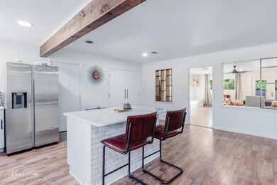 Kitchen with stainless steel fridge with ice dispe