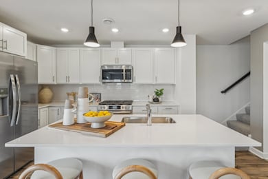 (Photo of a model home, actual homes finishes will vary) This kitchen is very open and connect seamlessly to the dinning area!