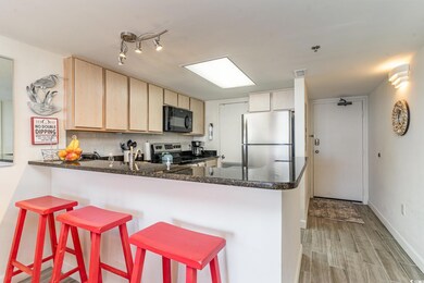 Kitchen with light brown cabinets, stainless steel
