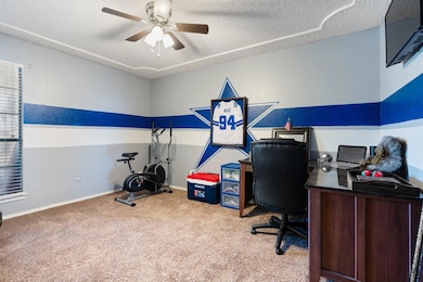Home office featuring carpet flooring, ceiling fan