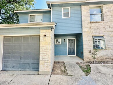 Multi unit property featuring a garage, stone sid
