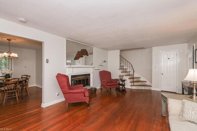 Living room with a fireplace and dark hardwood flooring