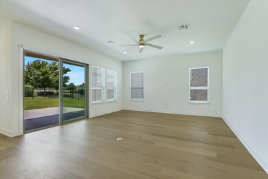 Unfurnished room with a ceiling fan, light wood-s