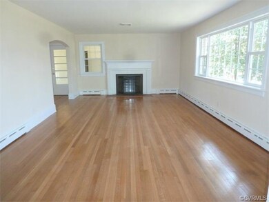 Beautiful family room with refinished hardwood flo