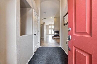 Carpeted entryway featuring vaulted ceiling