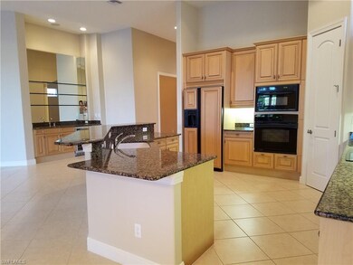 Kitchen with breakfast bar and built-in wet bar.