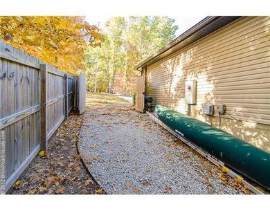 Exterior Back/Side. A double gate and gravel side-yard was built especially for RV/Boat Storage.