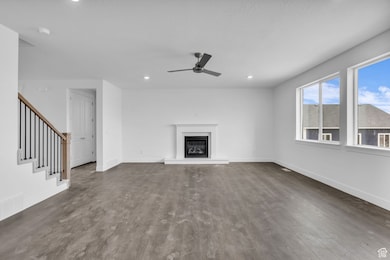 Family room with fireplace and ceiling fan.