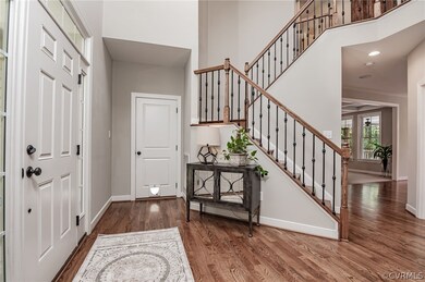 Gorgeous foyer with elegant side entry staircase &