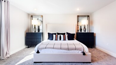 Bedroom featuring carpet flooring and baseboards