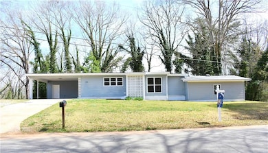 Single story home with an attached carport, concre