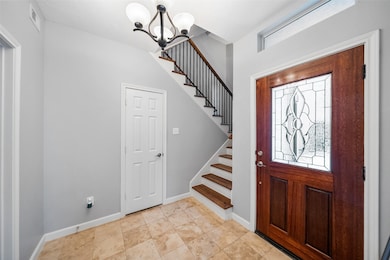 Entry with tasteful and timeless travertine.