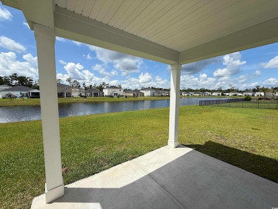 View of yard with a residential view, a patio, and a water view