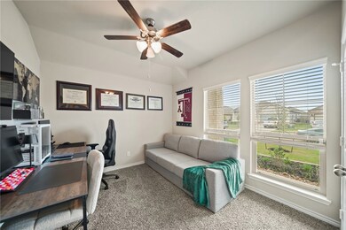 Office with baseboards, lofted ceiling, ceiling fa