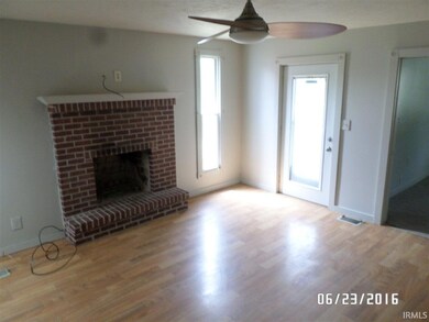 WITH VIEW OF FRONT DOOR AND FIREPLACE