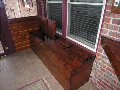 Storage in built-in benches on rear porch. This home has lots of wonderful wood work.