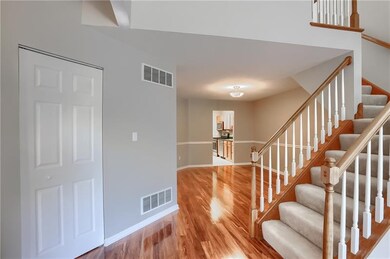 The entrance features striking modern flooring and