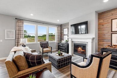 Resting on the center wall of the main level family room, the home's gas fireplace. This is the perfect backdrop for families of any lifestyle.