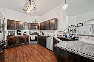 Kitchen featuring light stone counters, appliance
