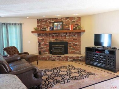 Large living room with a brick wood burning firepl