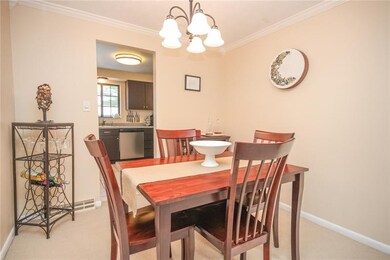 Dining space with crown molding and a neutral deco