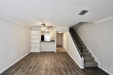 Unfurnished living room with stairway, dark wood 