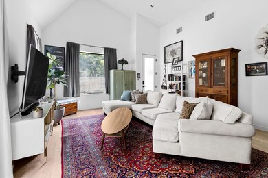 Living area featuring high vaulted ceiling and wo