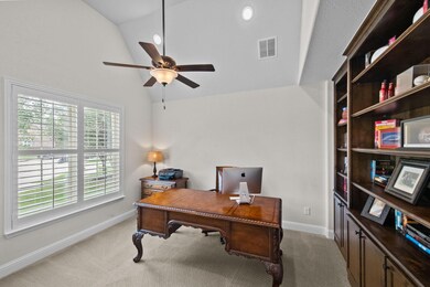 Immediately to the left of the stairs is a stately office featuring a wall of shelves, a walk-in closet, and plantation shutters; which you will see throughout.