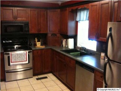 Fabulous kitchen boasts new tile flooring, distinguished new cabinetry, new countertops, and new stainless appliances.