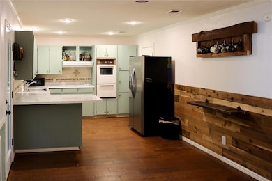 Kitchen featuring green cabinets, crown molding, o