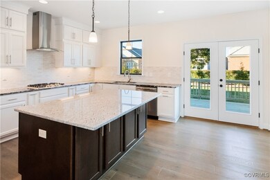Kitchen with wall chimney exhaust hood, white cabi